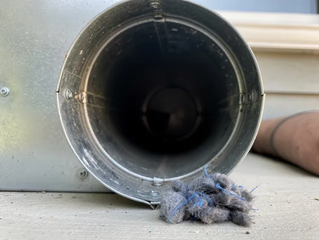 Waxhaw Dryer Vent Cleaning technician using specialized equipment to clear severe dryer vent blockage in Waxhaw